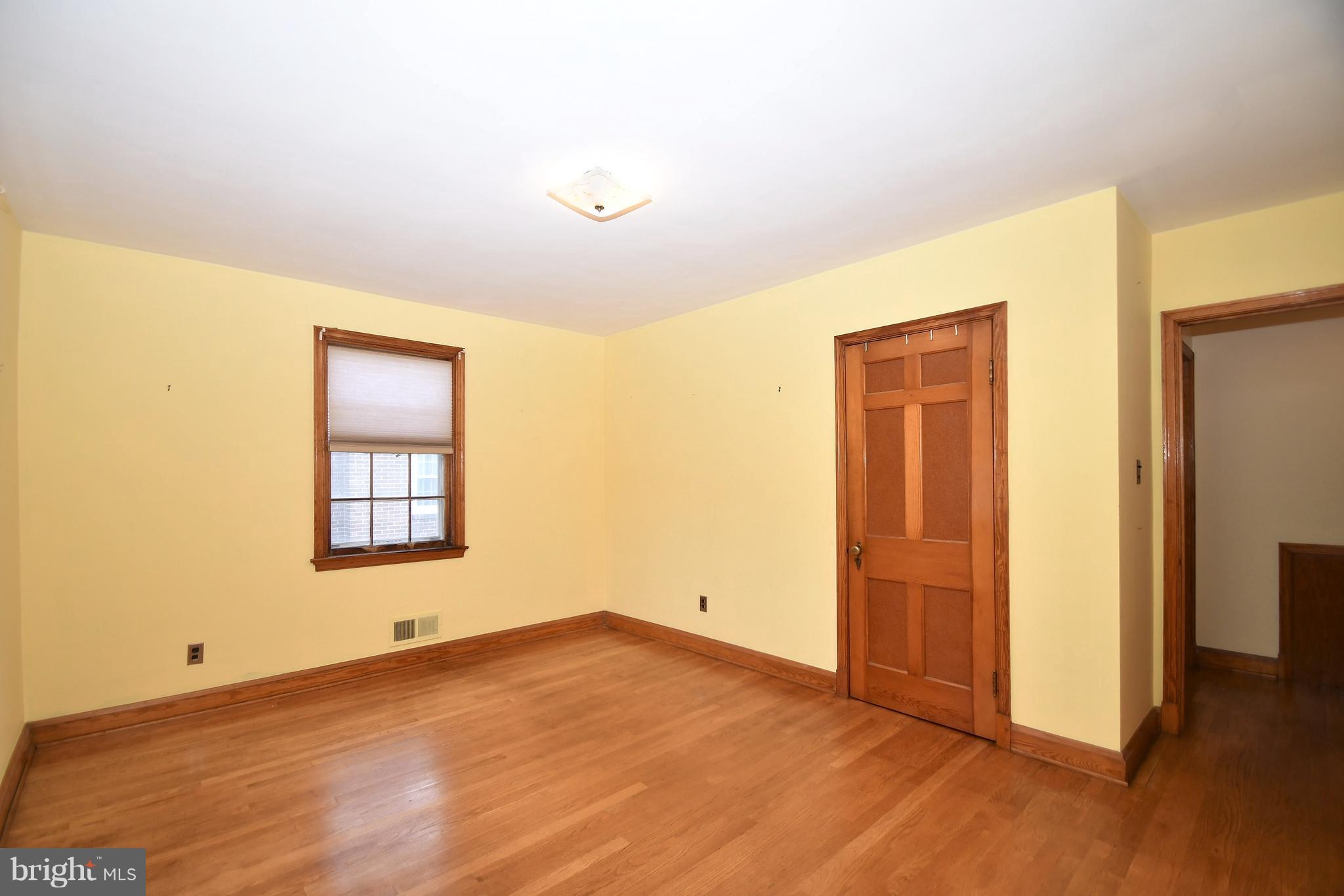 7009 Mornington Road Dundalk, MD 21222 - Photo 26 of 48 an empty room with wooden floor and windows