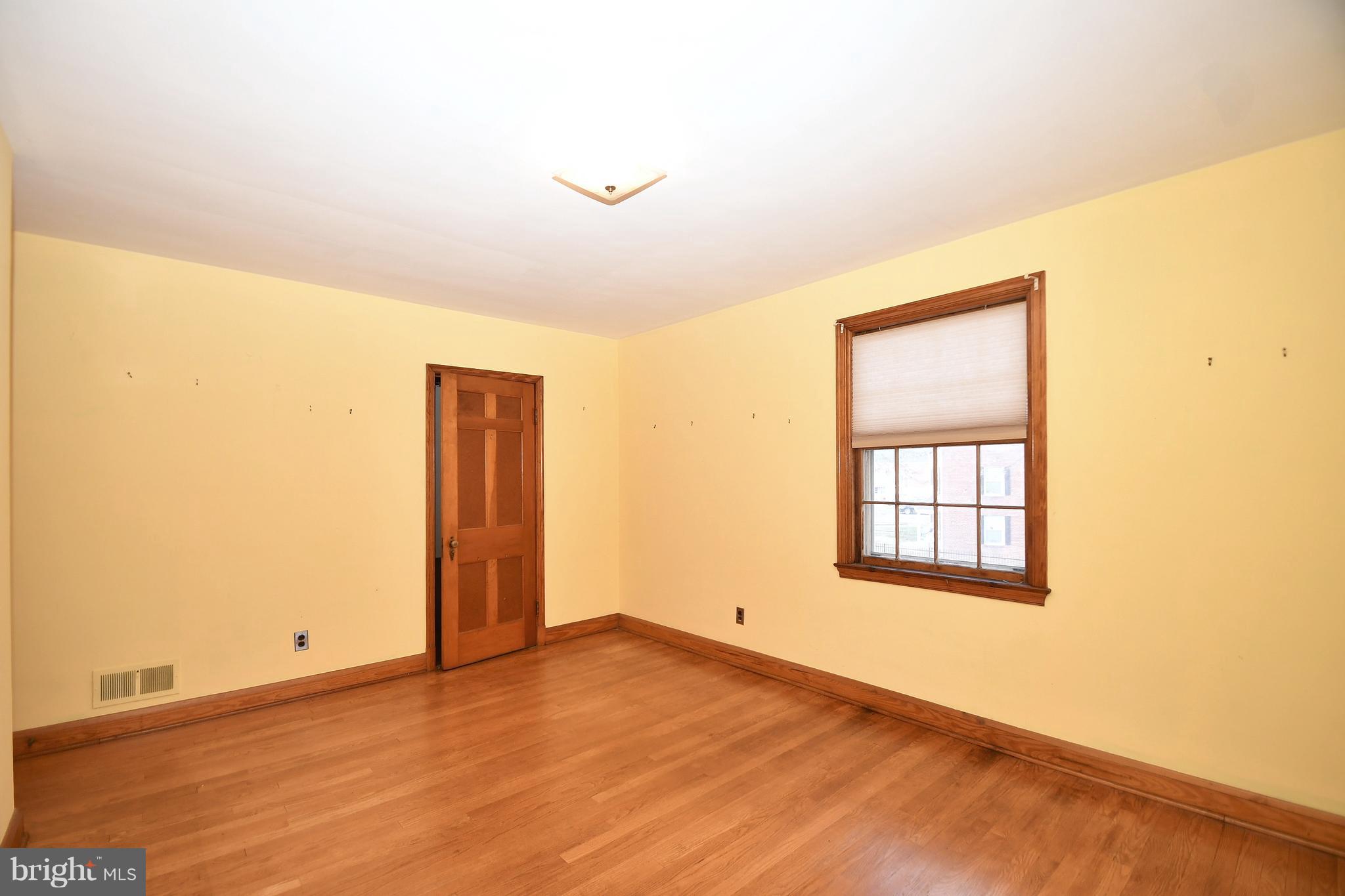 7009 Mornington Road Dundalk, MD 21222 - Photo 27 of 48 an empty room with wooden floor and windows