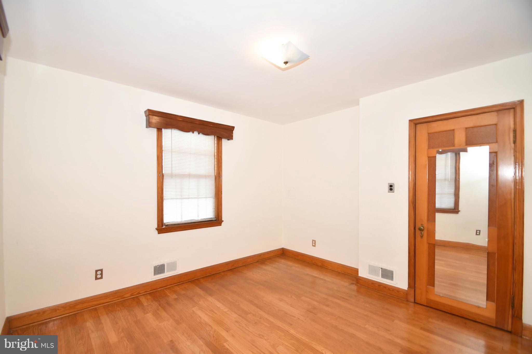 7009 Mornington Road Dundalk, MD 21222 - Photo 31 of 48 an empty room with wooden floor and windows