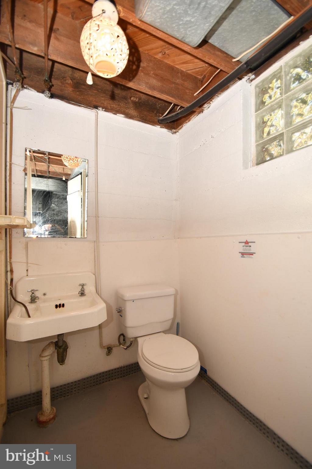 7009 Mornington Road Dundalk, MD 21222 - Photo 34 of 48 a bathroom with a toilet sink and mirror