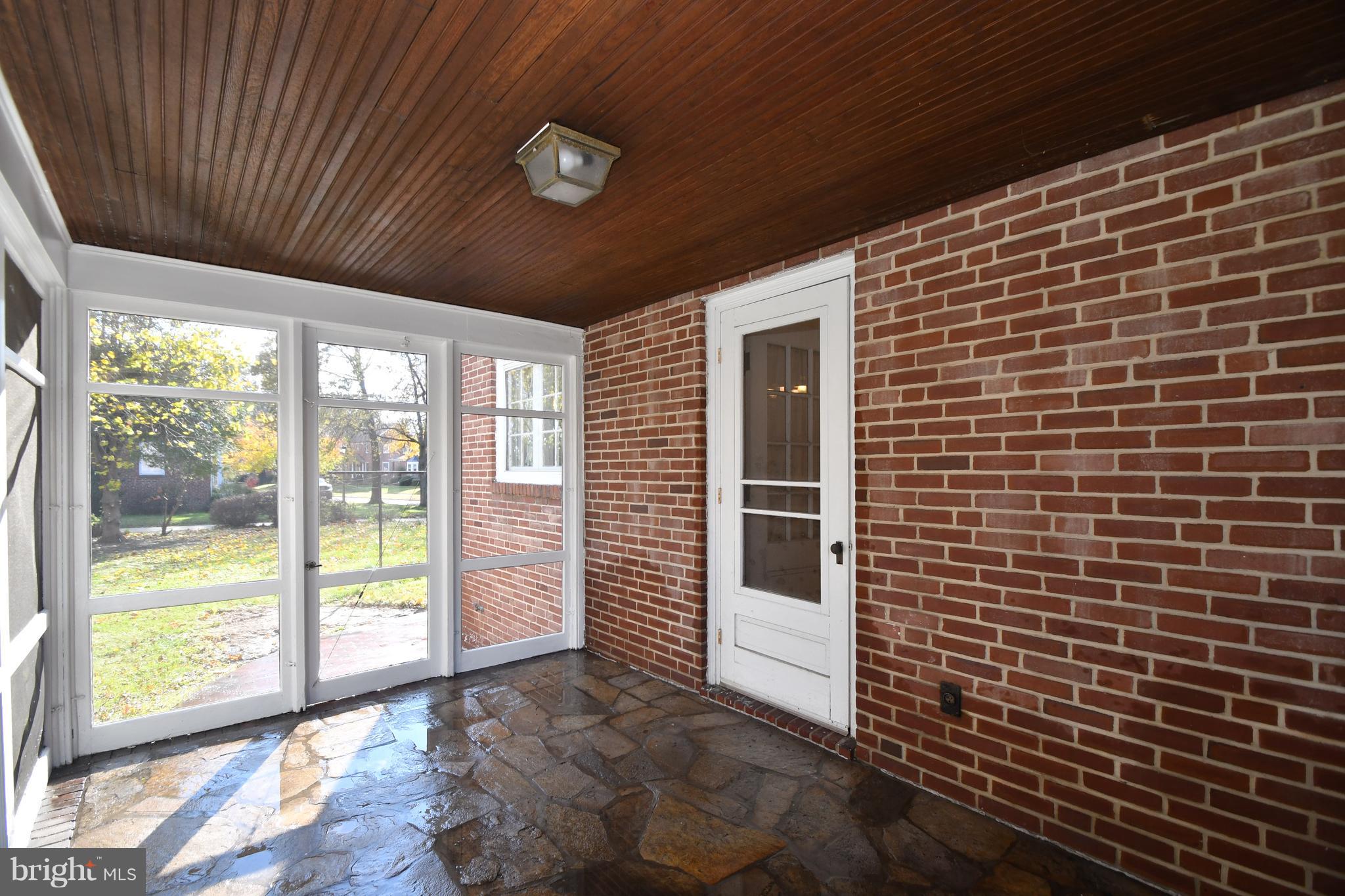 7009 Mornington Road Dundalk, MD 21222 - Photo 38 of 48 a view of a porch with a table and chairs
