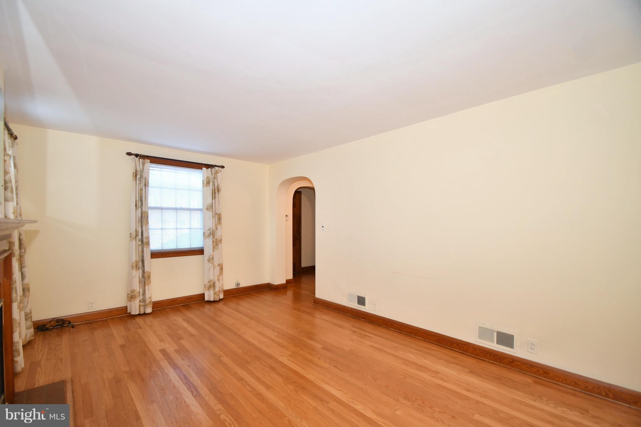 7009 Mornington Road Dundalk, MD 21222 - Photo 7 of 48 an empty room with wooden floor and windows