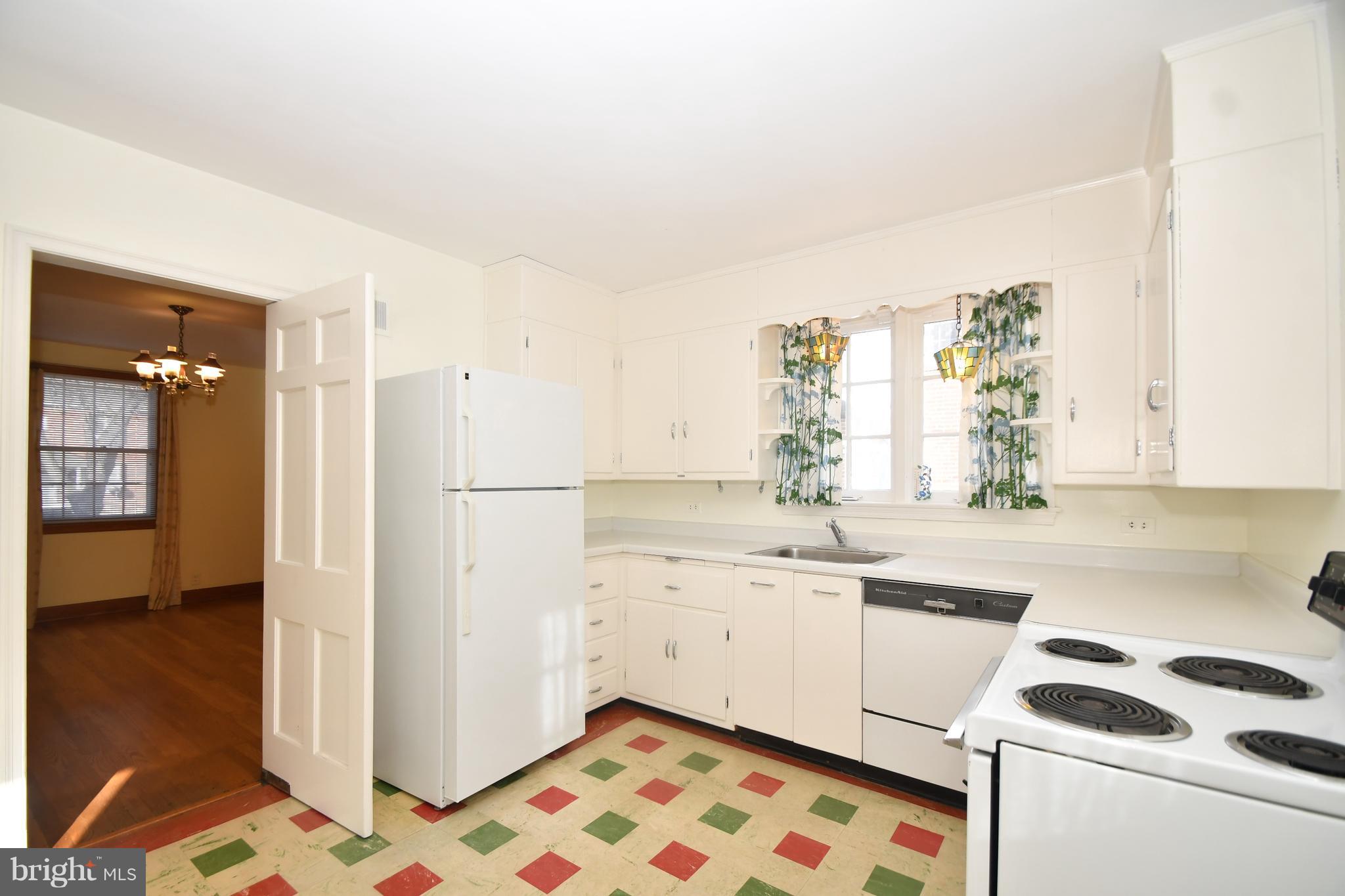 7009 Mornington Road Dundalk, MD 21222 - Photo 9 of 48 a kitchen with a sink a refrigerator and cabinets