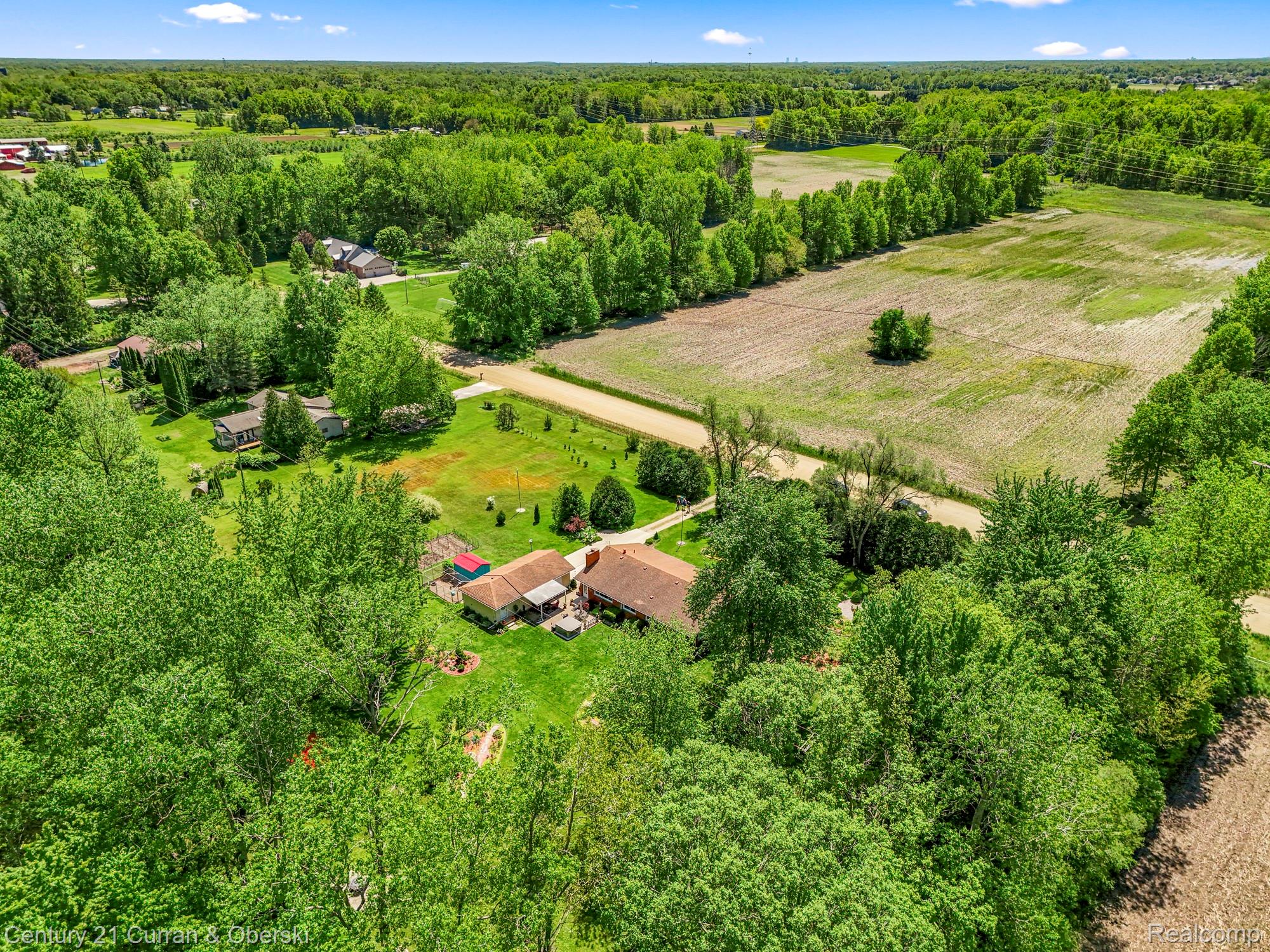 38894 South Huron Road New Boston, MI 48164 - Photo 43 of 44 Overview of rural landscape featuring a heavily wooded area