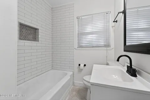 a bathroom with a sink a toilet and bathtub