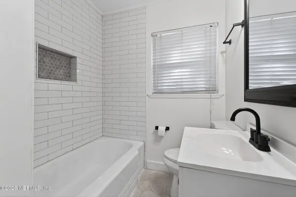 a bathroom with a sink a toilet and bathtub