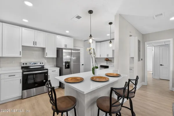 a kitchen that has a table and chairs in it