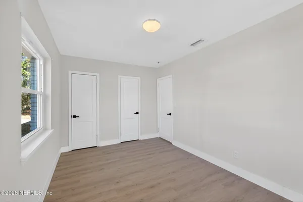 a view of room with window and wooden floor
