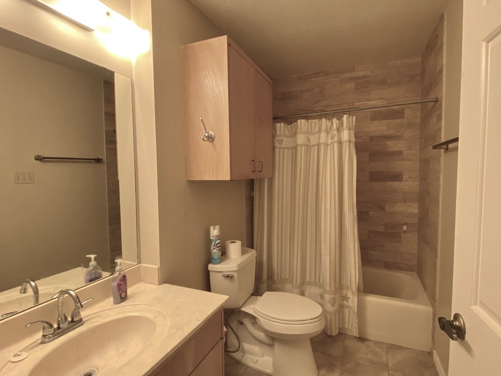 802 Lois Street Kerrville, TX 78028 - Photo 16 of 25 a bathroom with a sink toilet and shower