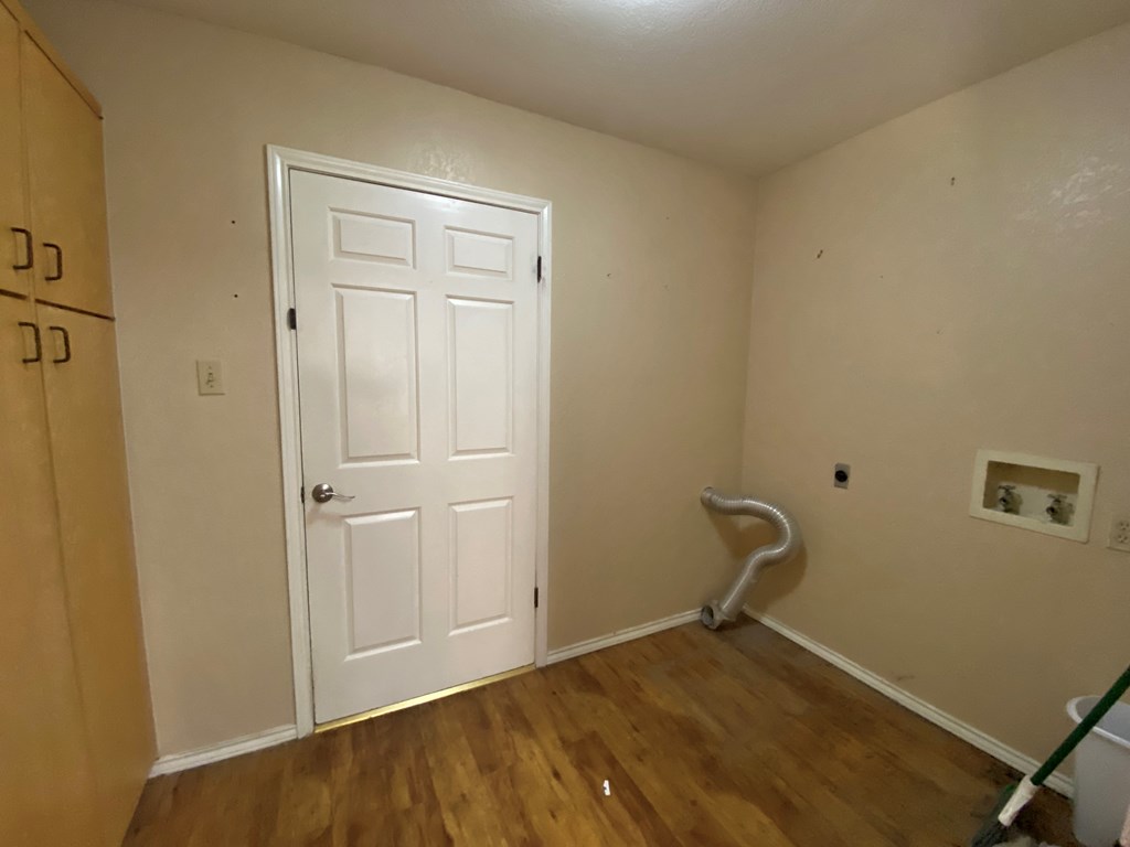 802 Lois Street Kerrville, TX 78028 - Photo 18 of 25 a view of a room with wooden floor and bathroom