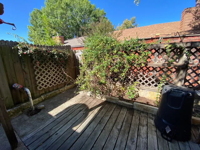 a view of a balcony with wooden floor