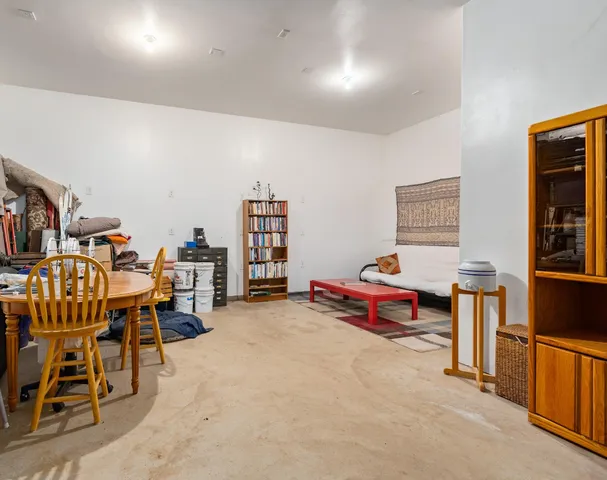 a view of a wooden house with a swimming pool and trees
