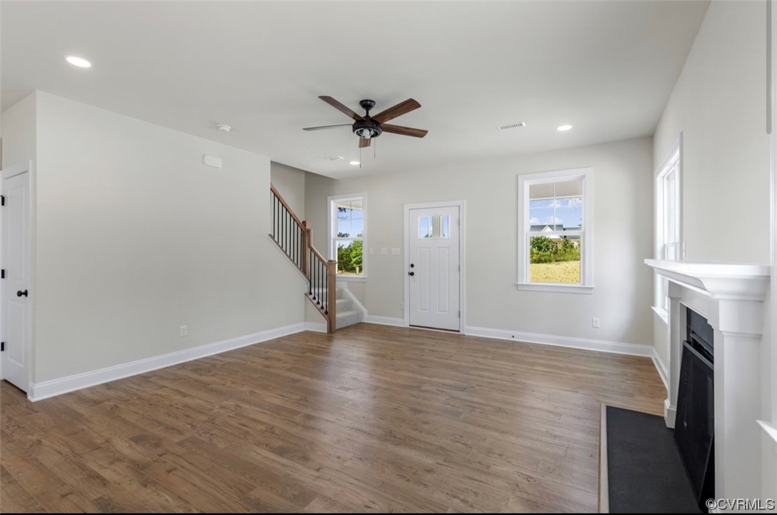 950 Kennon Road Bumpass, VA 23024 - Photo 6 of 26 an empty room with windows and fireplace