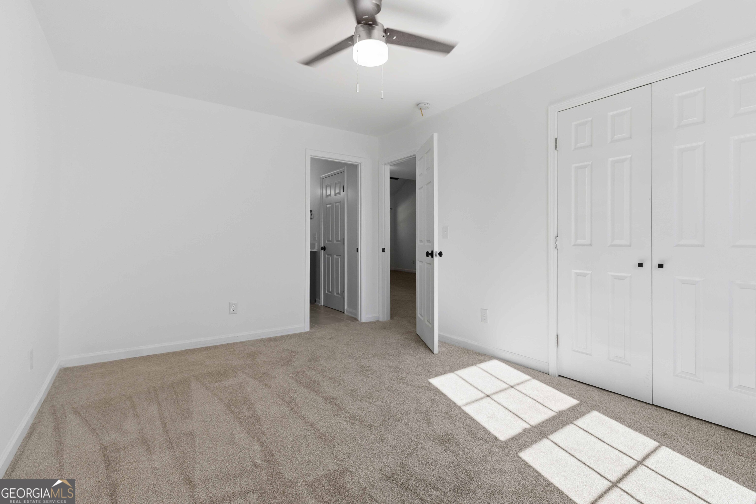 6938 Shadow Ridge Lane Stone Mountain, GA 30087 - Photo 12 of 27 a view of an empty room and a ceiling fan