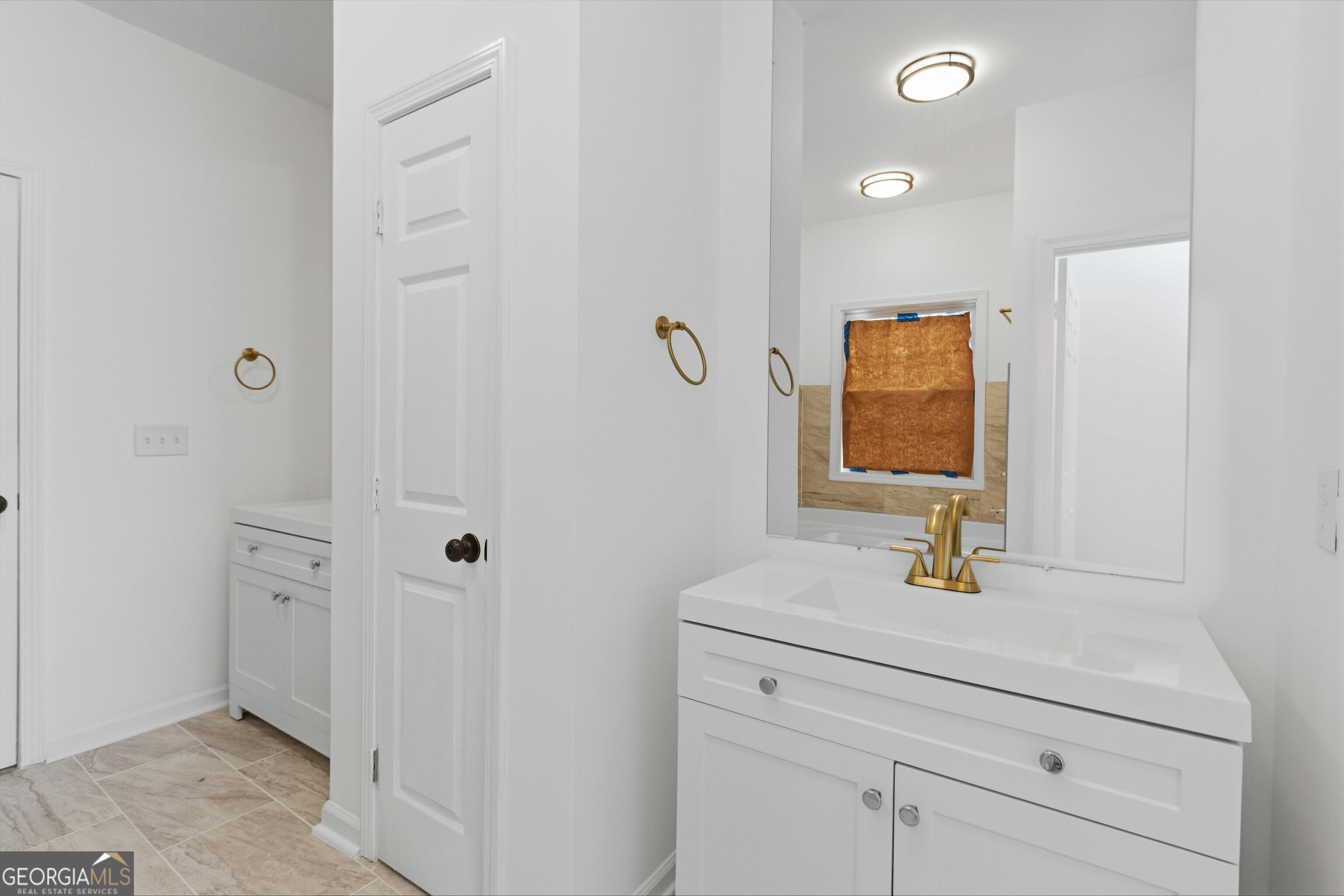 6938 Shadow Ridge Lane Stone Mountain, GA 30087 - Photo 14 of 27 a bathroom with a sink and a mirror
