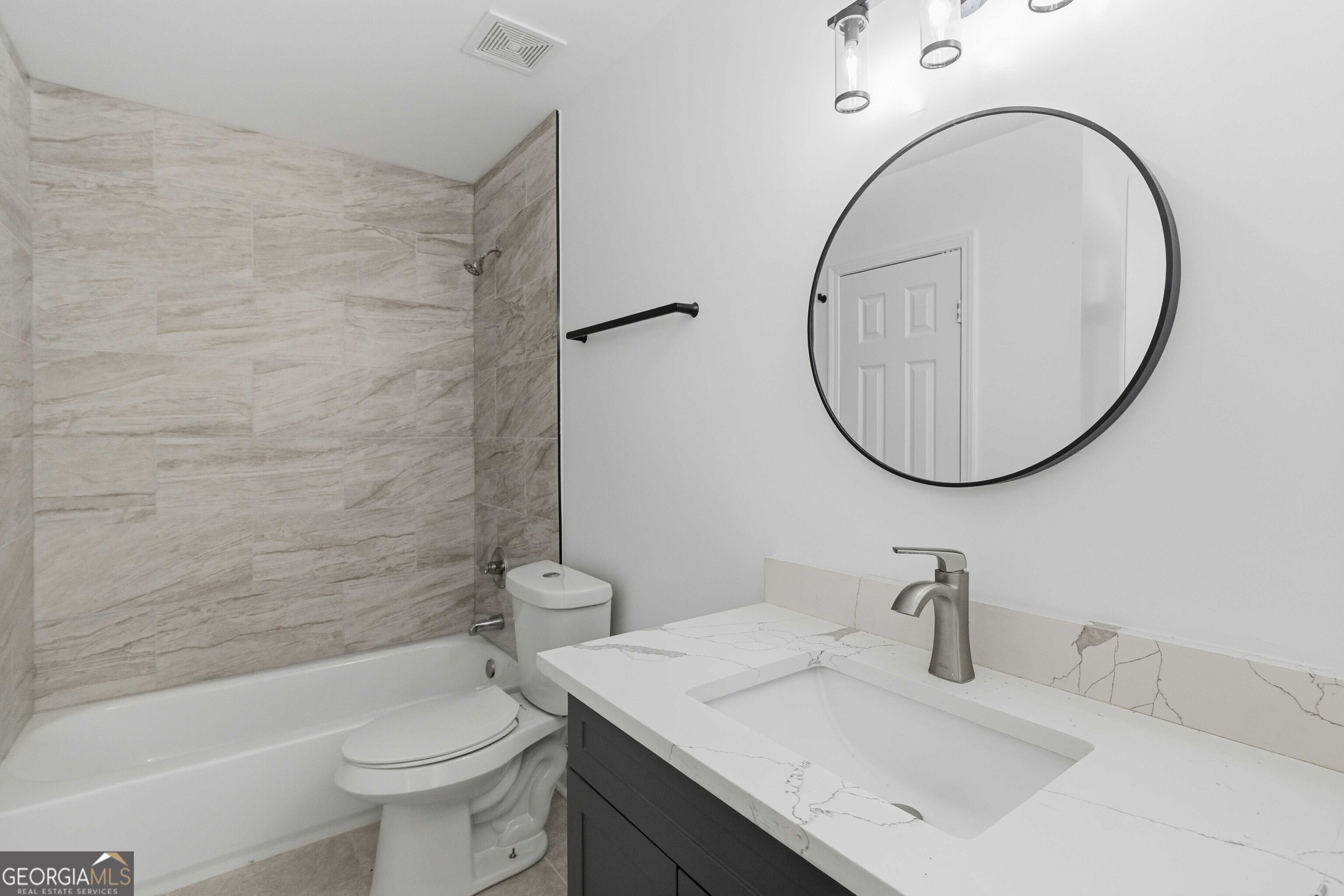 6938 Shadow Ridge Lane Stone Mountain, GA 30087 - Photo 17 of 27 a bathroom with a sink a toilet and a mirror