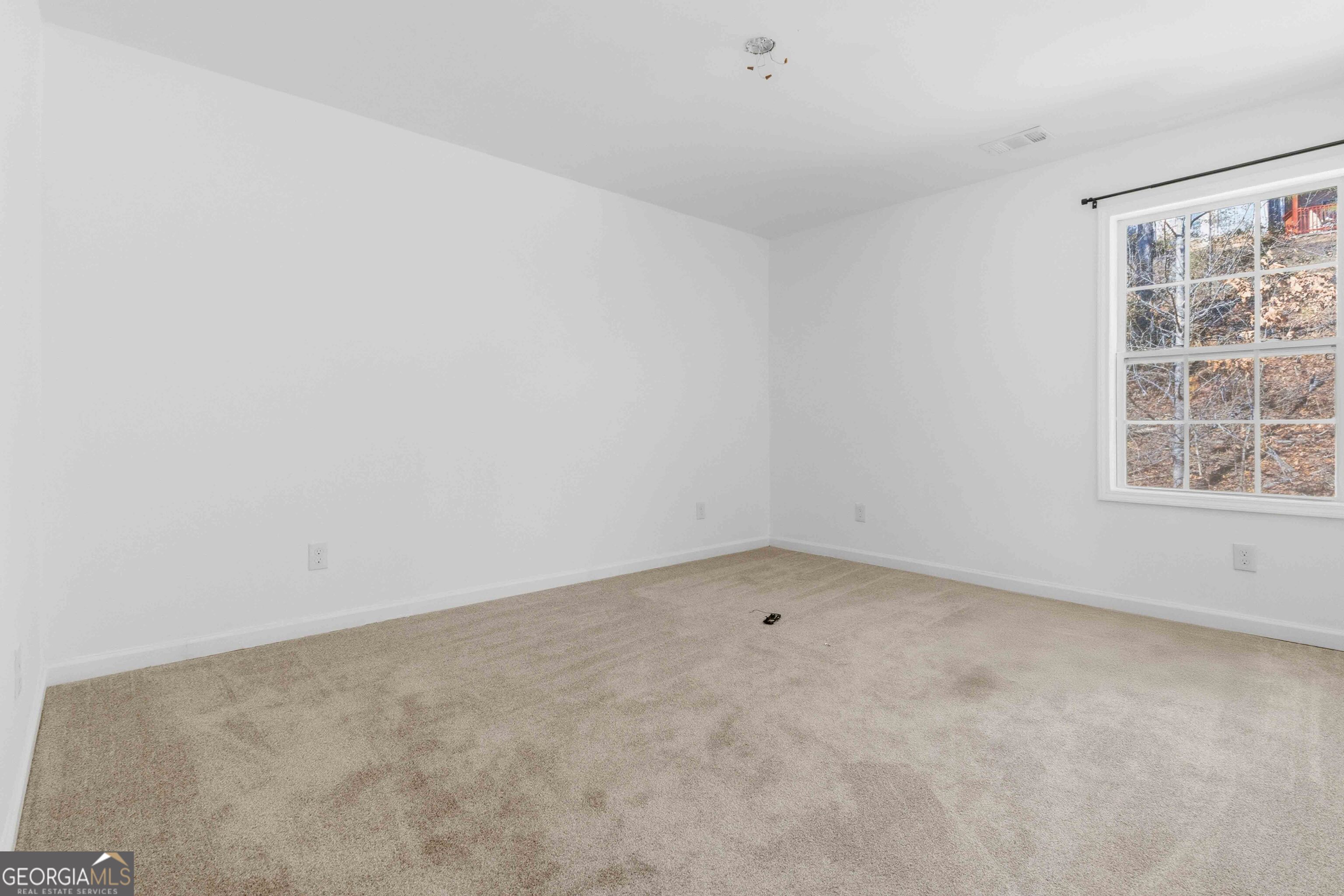 6938 Shadow Ridge Lane Stone Mountain, GA 30087 - Photo 19 of 27 an empty room with a window