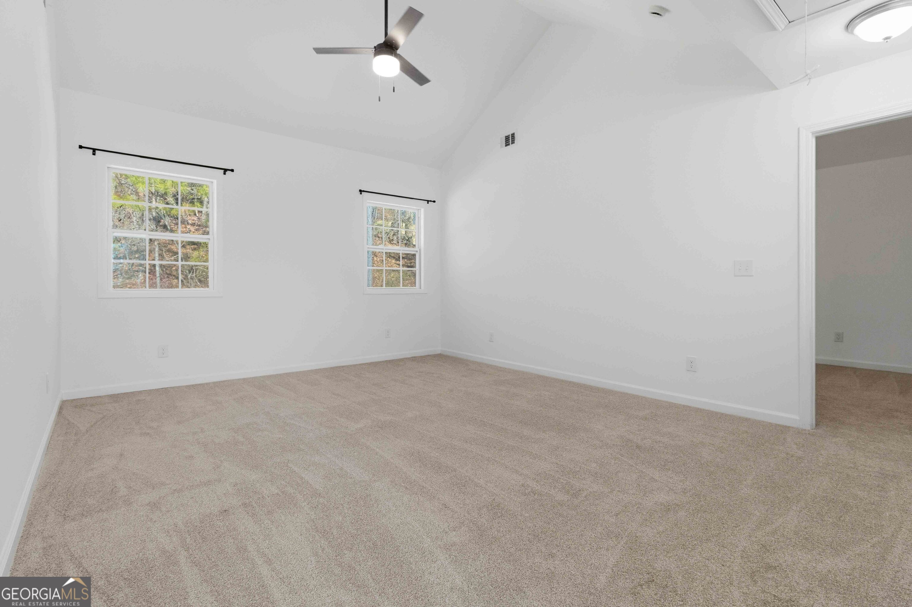 6938 Shadow Ridge Lane Stone Mountain, GA 30087 - Photo 20 of 27 an empty room with windows