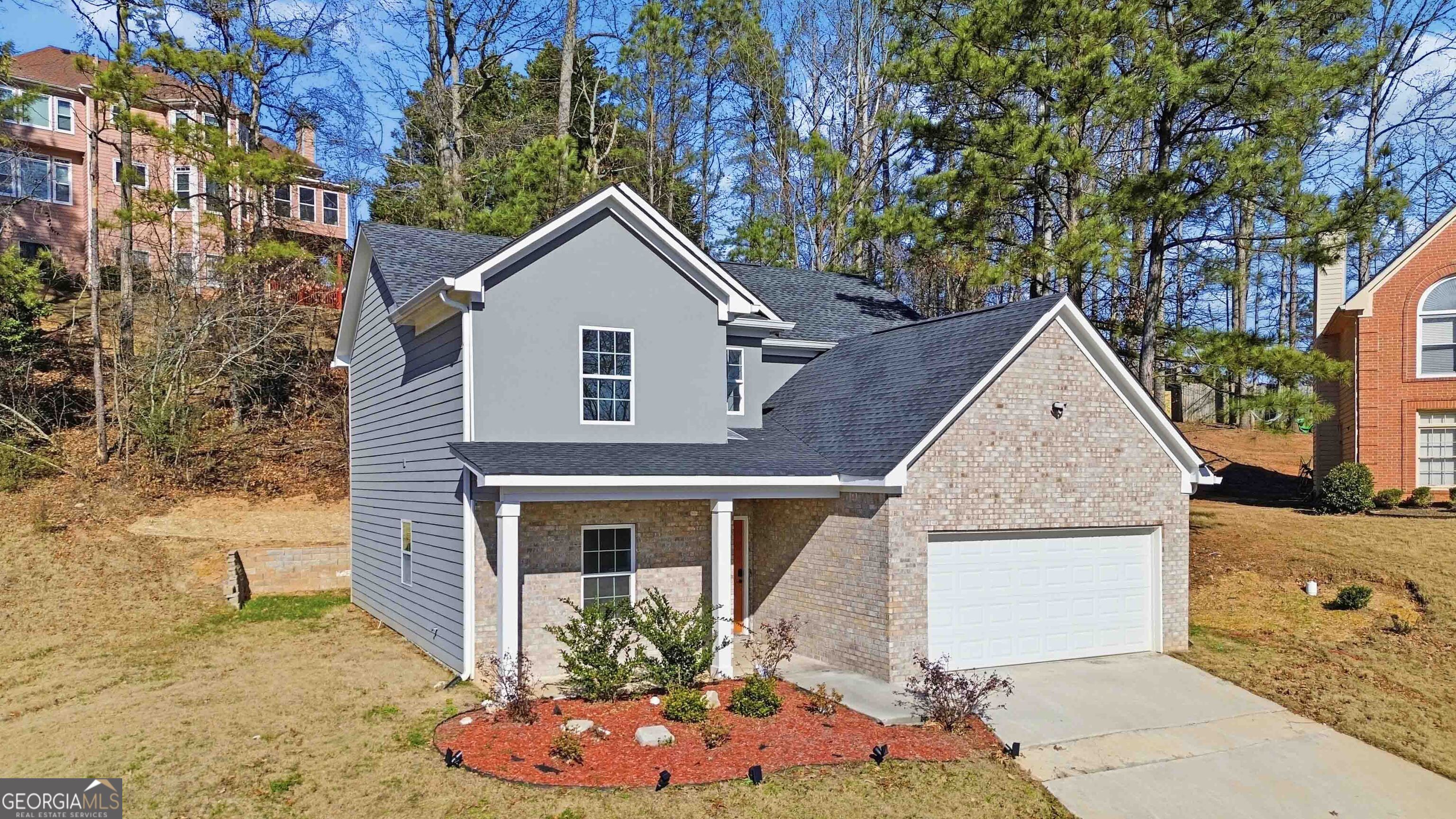 6938 Shadow Ridge Lane Stone Mountain, GA 30087 - Photo 2 of 27 a view of a house with a yard