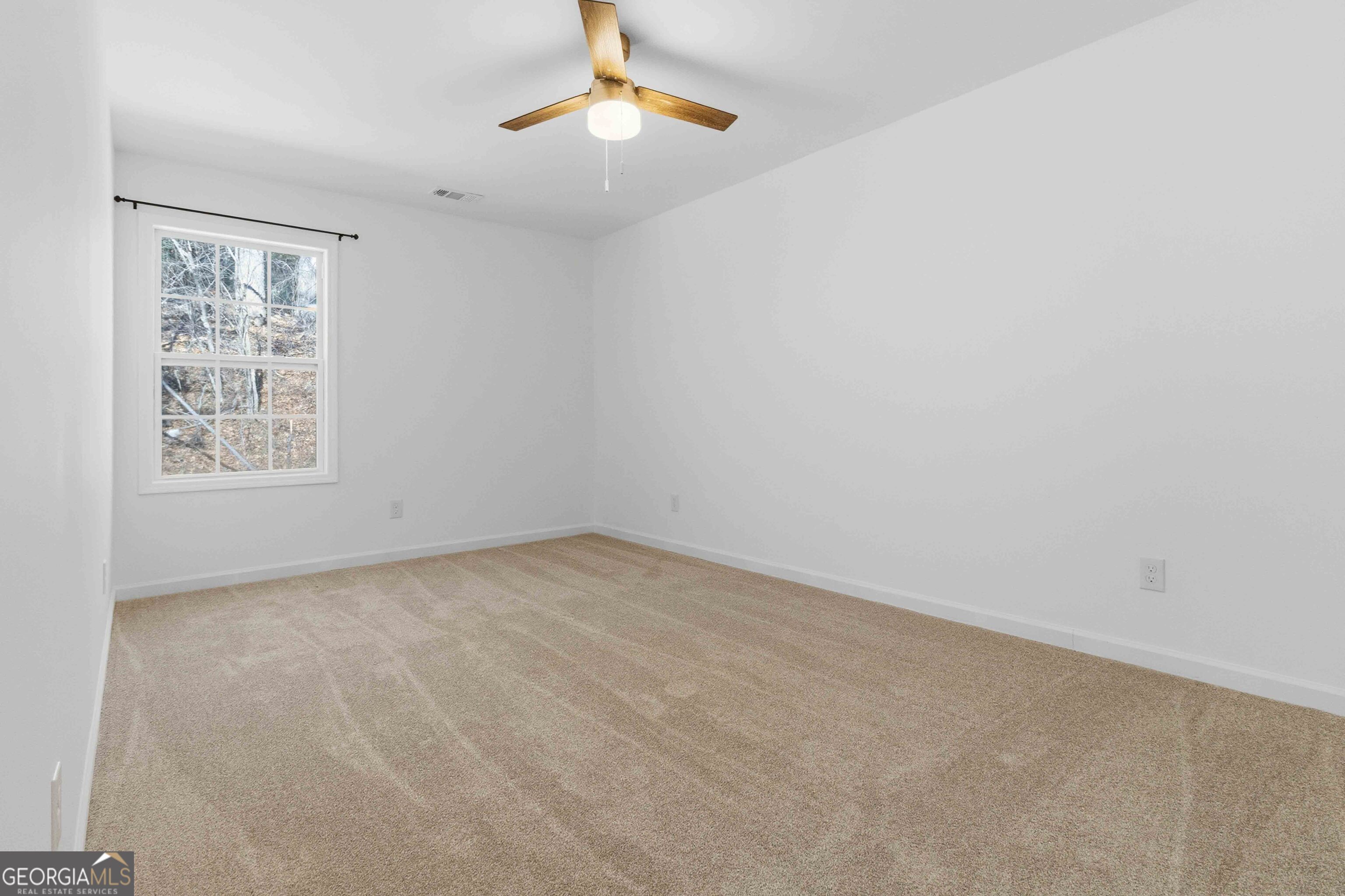 6938 Shadow Ridge Lane Stone Mountain, GA 30087 - Photo 22 of 27 an empty room with windows