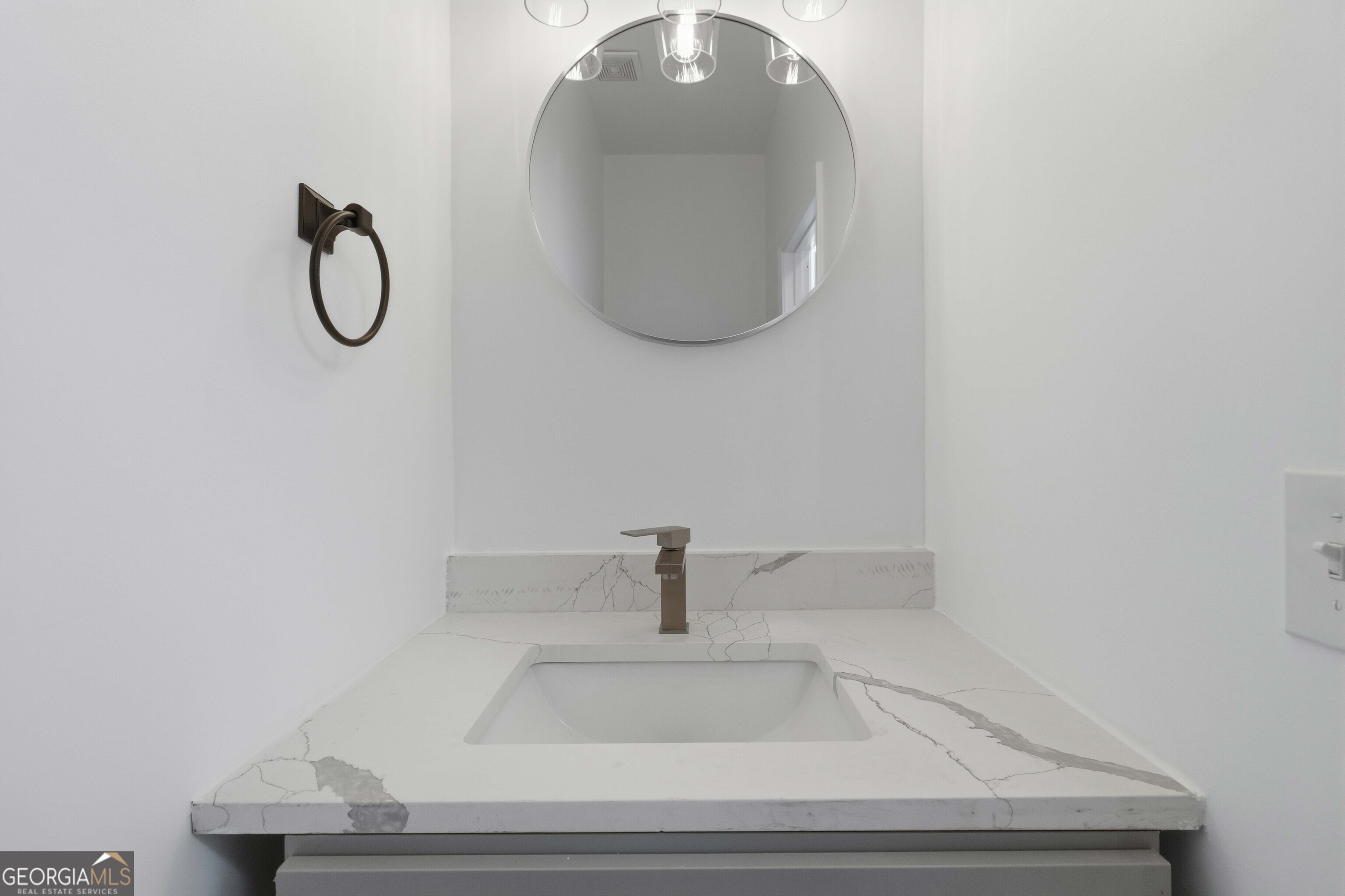 6938 Shadow Ridge Lane Stone Mountain, GA 30087 - Photo 23 of 27 a bathroom with a sink and mirror