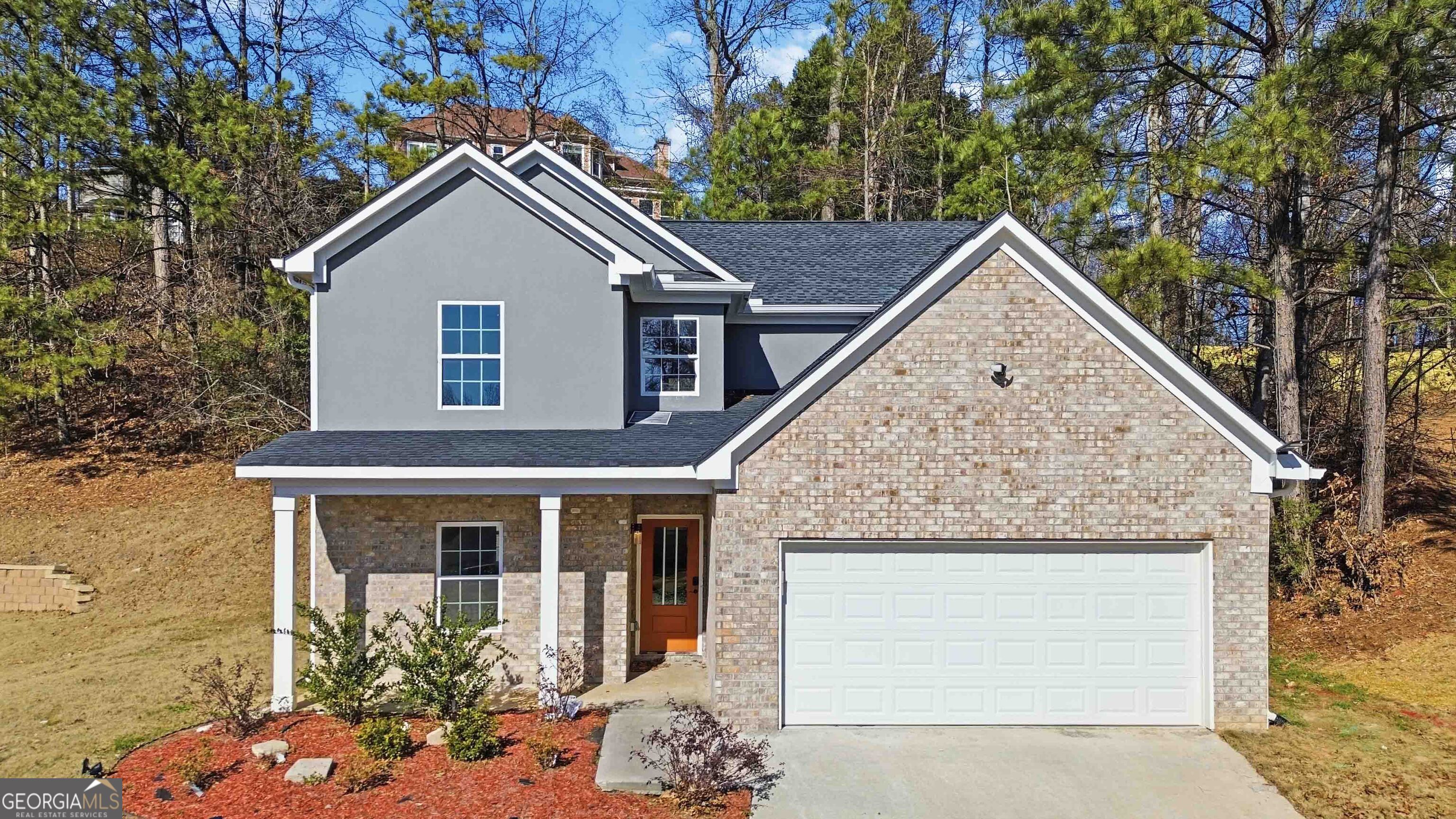 6938 Shadow Ridge Lane Stone Mountain, GA 30087 - Photo 3 of 27 a view of a house with a yard