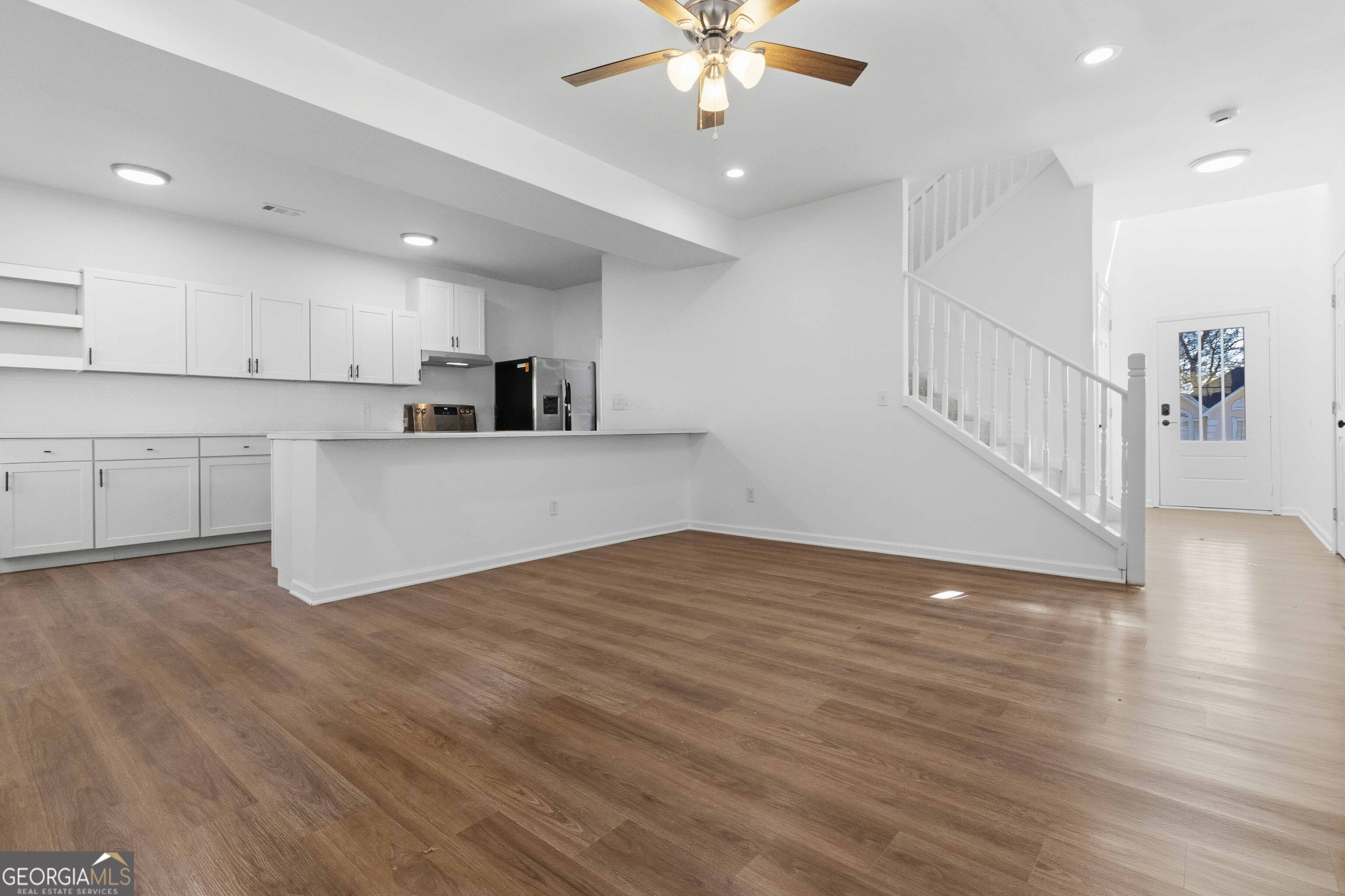 6938 Shadow Ridge Lane Stone Mountain, GA 30087 - Photo 7 of 27 a view of kitchen with cabinets and wooden floor
