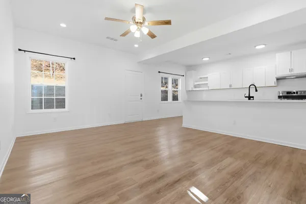 a view of a kitchen with a stove cabinets and wooden floor