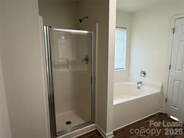 a bathroom with a bathtub and a shower