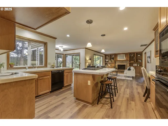a kitchen with a sink a counter top space and stainless steel appliances