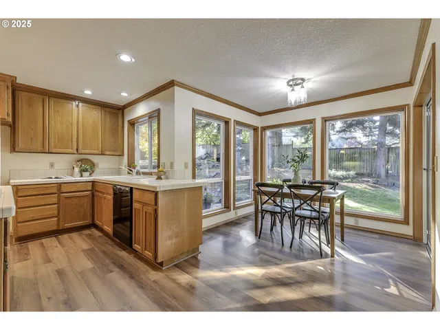 a kitchen with a table chairs and a sink