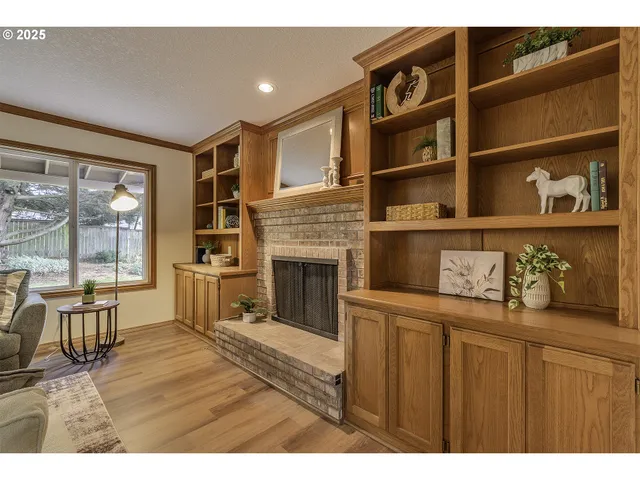 a living room with hard wood floors and a fireplace