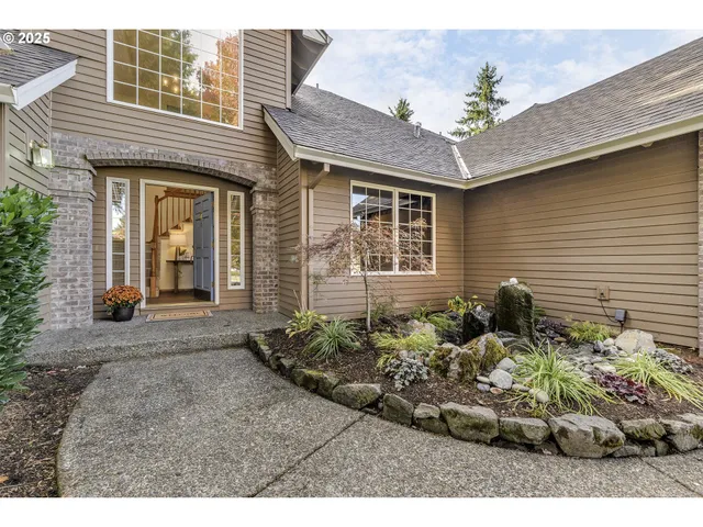 a view of a house with a small yard and plants