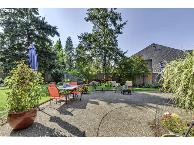 a view of a patio with table and chairs and potted plants