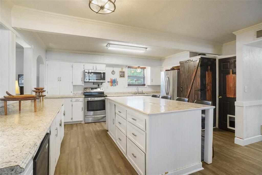 3200 Farm To Market 51 Decatur, TX 76234 - Photo 5 of 22 a kitchen with white cabinets and stainless steel appliances