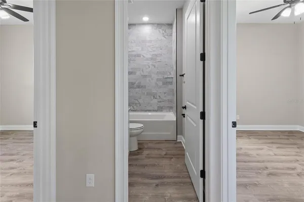 a view of a bathroom from a corridor