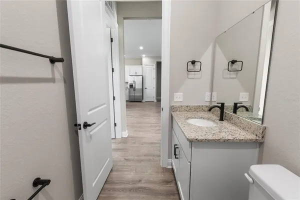a bathroom with a granite countertop sink mirror and shower