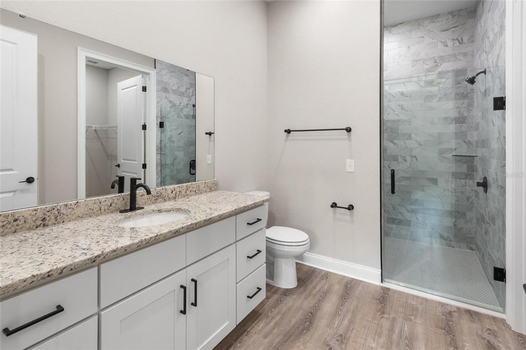 3620 Garrard Road Fort Meade, FL 33841 - Photo 23 of 33 a bathroom with a granite countertop sink a toilet and shower