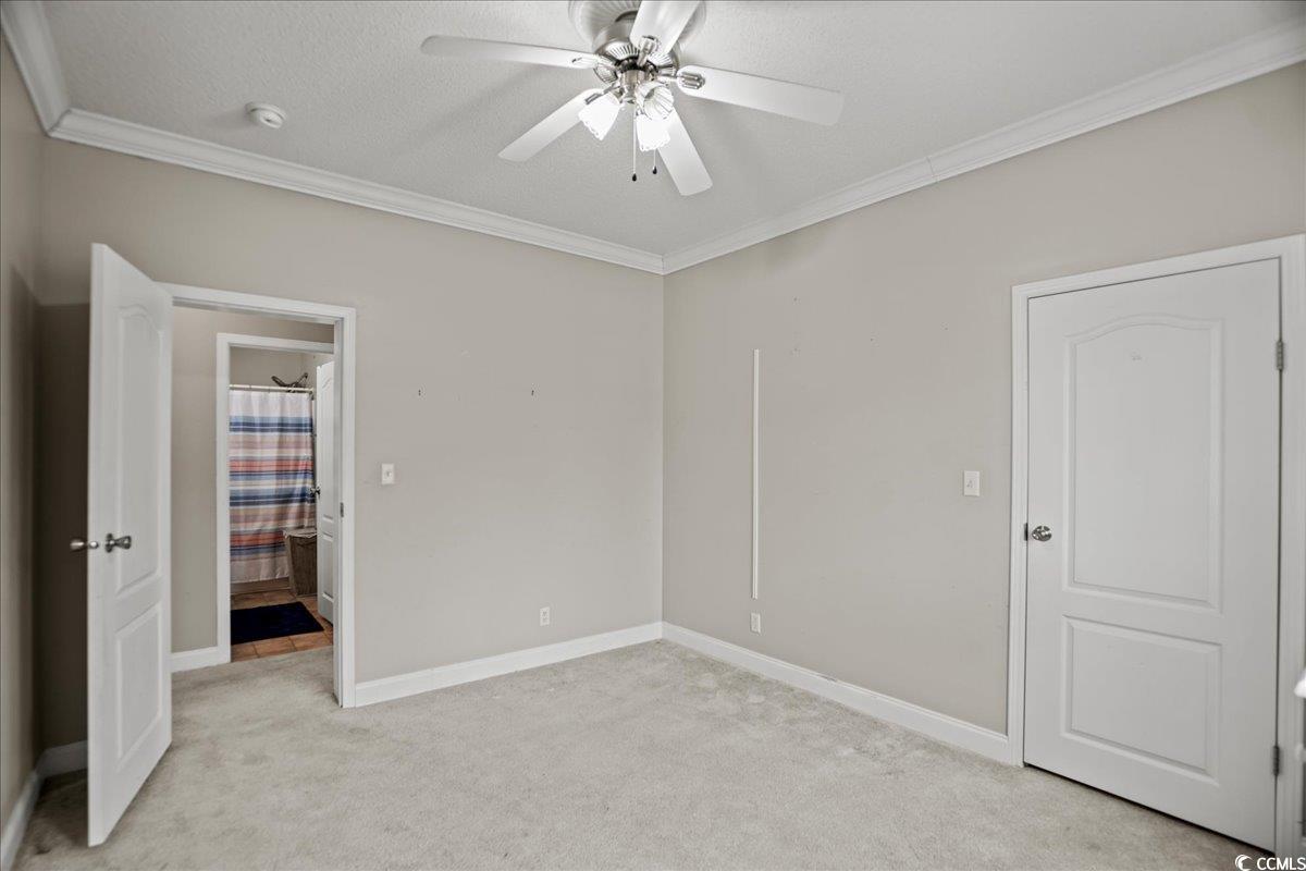706 Beverly Hills Road Camden, SC 29020 - Photo 11 of 25 Unfurnished bedroom with light colored carpet, a ceiling fan, and ornamental molding