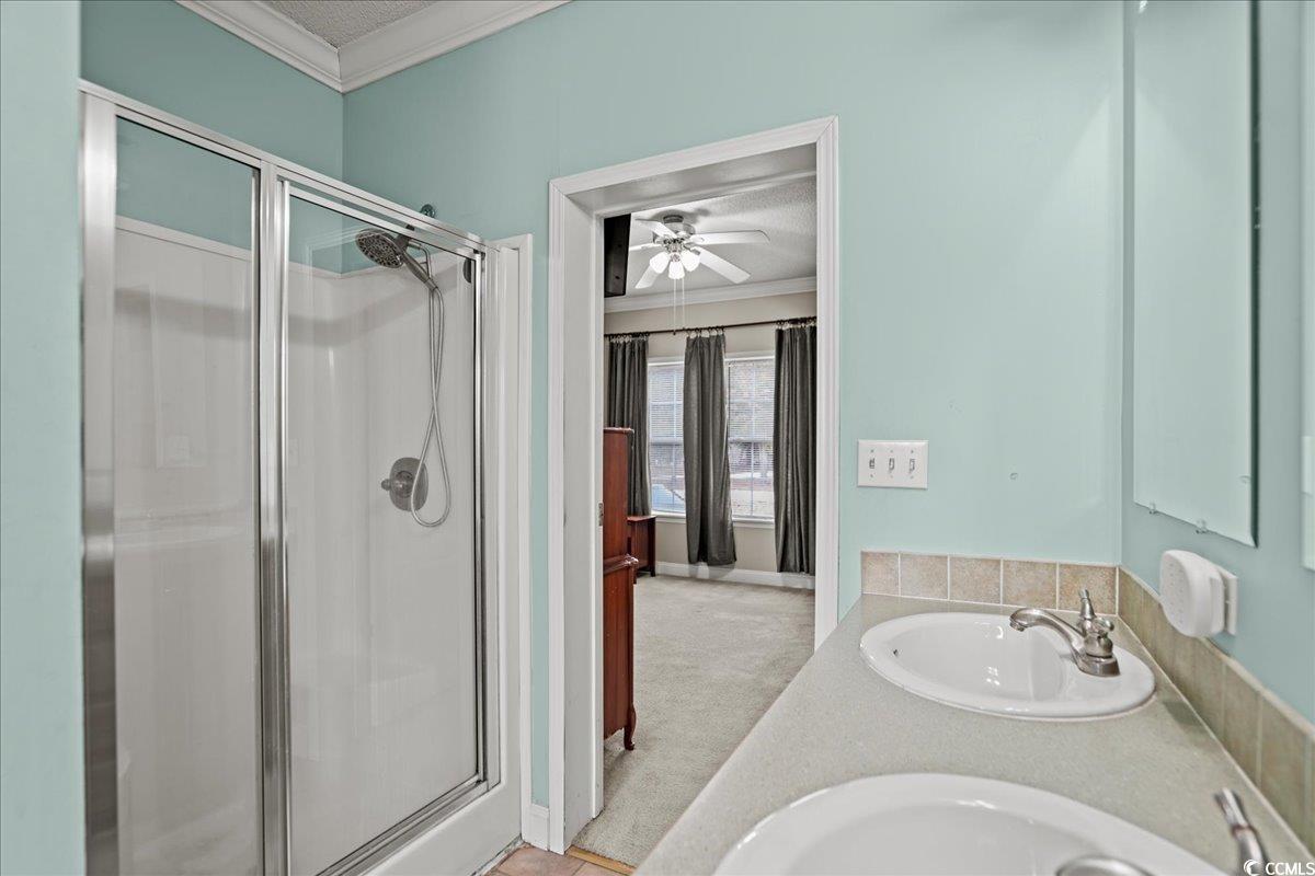706 Beverly Hills Road Camden, SC 29020 - Photo 17 of 25 Full bathroom with ornamental molding, a stall shower, double vanity, a textured ceiling, and light carpet