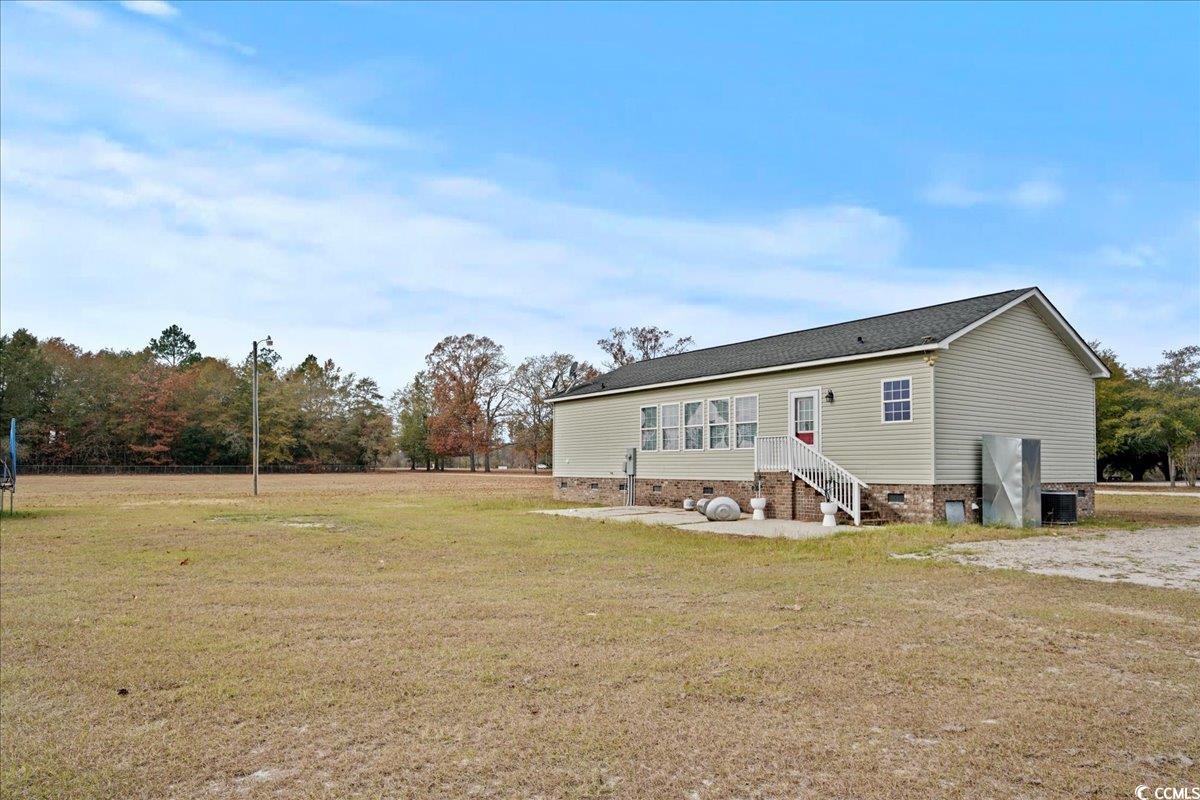 706 Beverly Hills Road Camden, SC 29020 - Photo 21 of 25 Back of property featuring crawl space, a lawn, a shingled roof, and entry steps