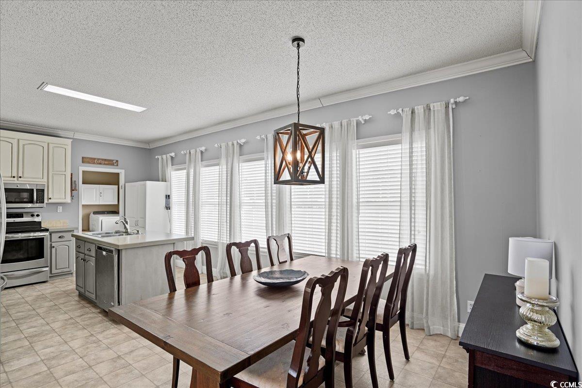 706 Beverly Hills Road Camden, SC 29020 - Photo 6 of 25 Dining room with ornamental molding, a textured ceiling, and a chandelier