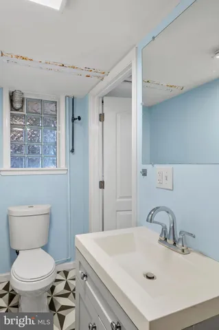 a view of a room with wooden floor and fan