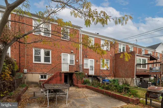 a backyard of a house with table and chairs