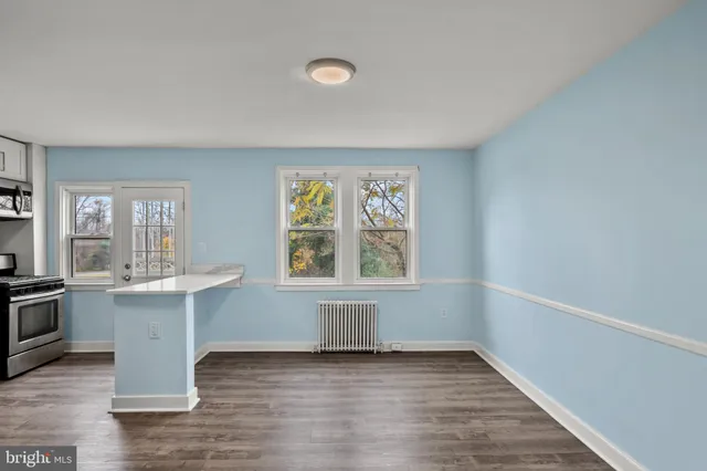 a kitchen with a refrigerator and a stove top oven