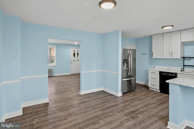 a kitchen with stainless steel appliances a stove a sink a refrigerator and a microwave