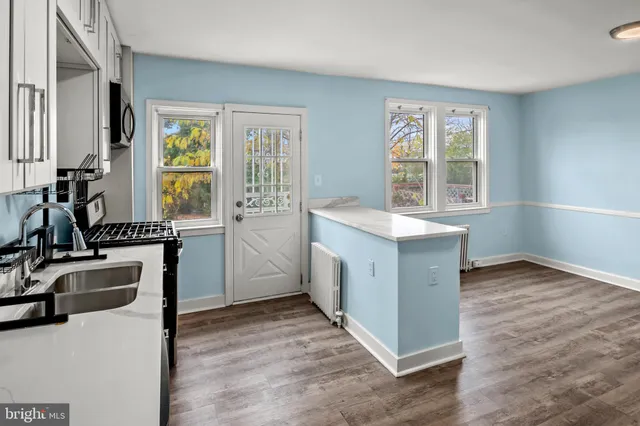 a kitchen with a refrigerator sink and cabinets