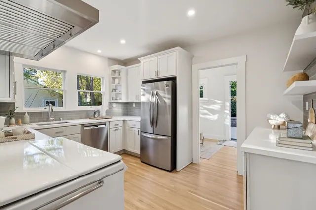 a kitchen with a refrigerator sink and cabinets
