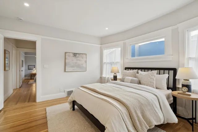 a bedroom with a bed and a night stand