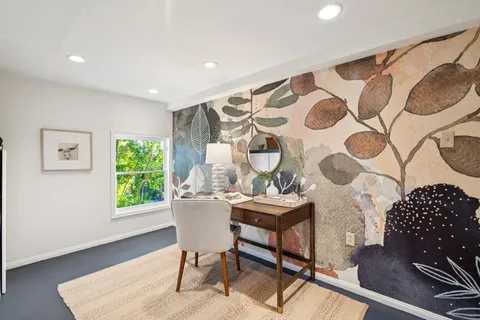 a living room with a bed and a window